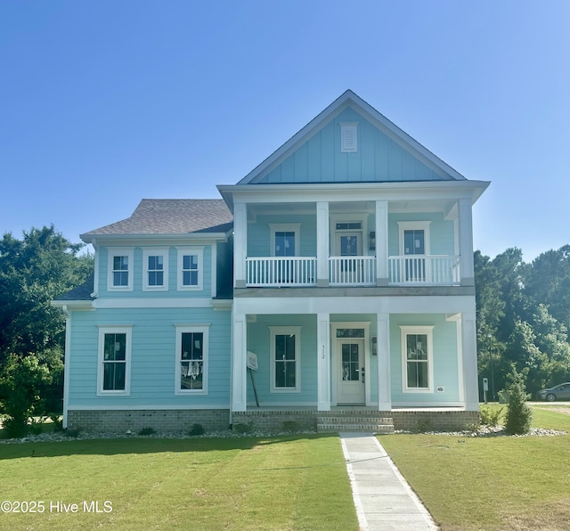 312 Cannonsgate Dr, Newport, NC 28570 - view of front of house featuring a balcony, a porch, a front lawn, and a shingled roof