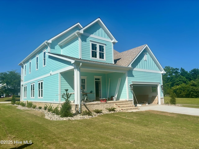 312 Cannonsgate Dr, Newport, NC 28570 - view of front of property with a porch, board and batten siding, driveway, and a front yard