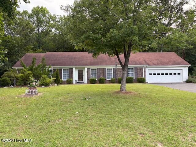 2904 Jason Dr, Rocky Mount, NC 27803 - ranch-style house featuring asphalt driveway, a garage, and a front lawn