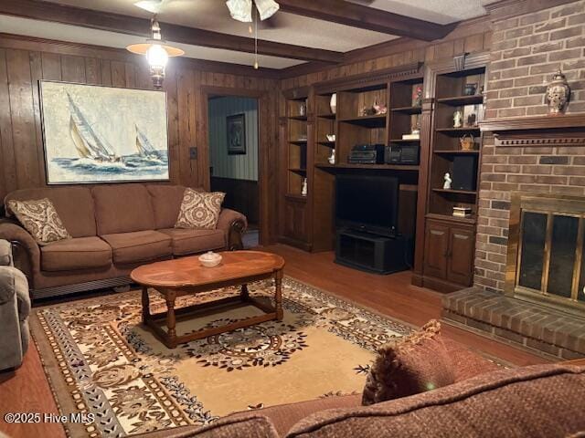 2904 Jason Dr, Rocky Mount, NC 27803 - living room with wooden walls, wood finished floors, a brick fireplace, and beam ceiling