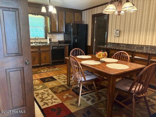 2904 Jason Dr, Rocky Mount, NC 27803 - dining space with wallpapered walls, light wood-style flooring, and a chandelier