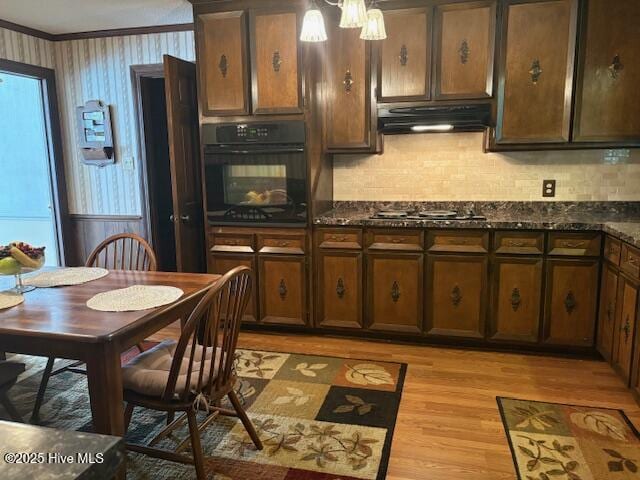 2904 Jason Dr, Rocky Mount, NC 27803 - kitchen with black appliances, light wood-type flooring, under cabinet range hood, crown molding, and tasteful backsplash
