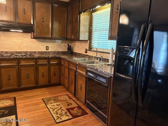 2904 Jason Dr, Rocky Mount, NC 27803 - kitchen featuring black appliances, under cabinet range hood, light wood finished floors, tasteful backsplash, and dark stone counters