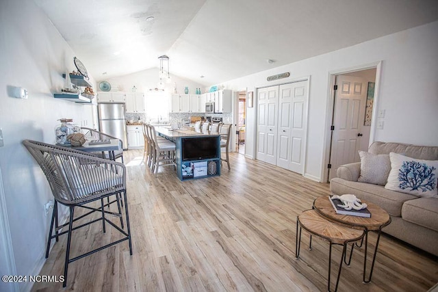 130 Crab St, Holden Beach, NC 28462 - living area featuring vaulted ceiling and light wood-style flooring