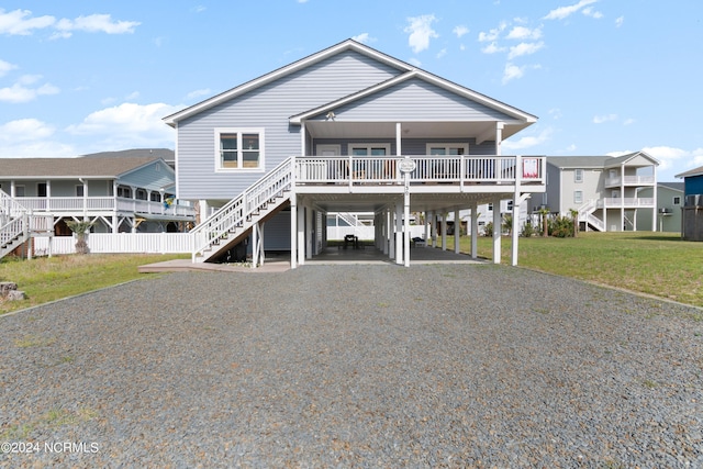 130 Crab St, Holden Beach, NC 28462 - beach home featuring stairs, a carport, driveway, a front yard, and a porch