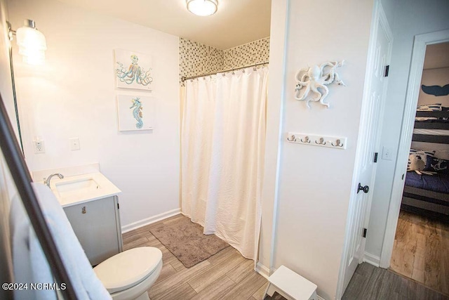 130 Crab St, Holden Beach, NC 28462 - bathroom featuring vanity, wood finished floors, and curtained shower