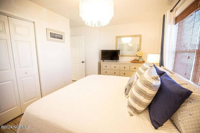 130 Crab St, Holden Beach, NC 28462 - bedroom featuring a chandelier, a closet, and wood finished floors