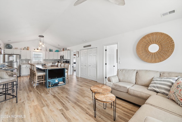 130 Crab St, Holden Beach, NC 28462 - living area featuring lofted ceiling and light wood-style floors