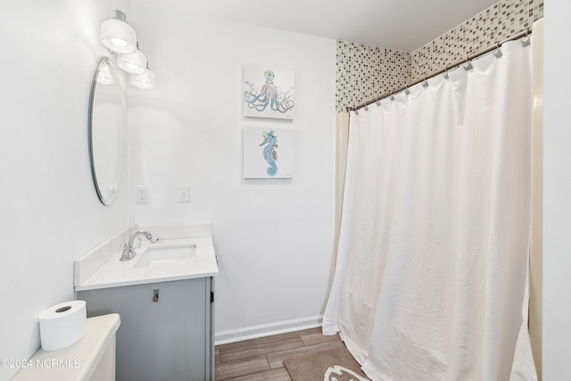 130 Crab St, Holden Beach, NC 28462 - full bathroom featuring vanity, wood finished floors, and a shower with shower curtain