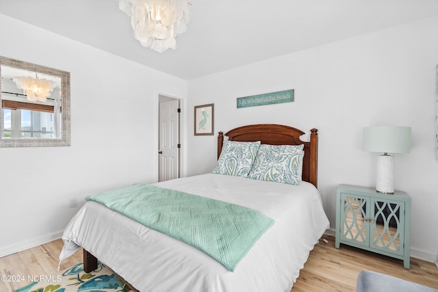 130 Crab St, Holden Beach, NC 28462 - bedroom featuring a chandelier and wood finished floors