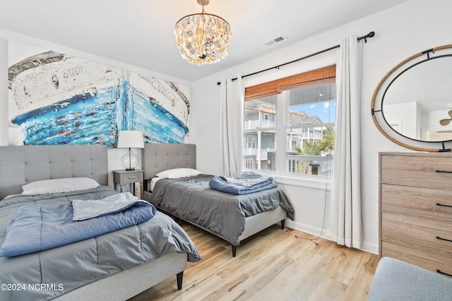 130 Crab St, Holden Beach, NC 28462 - bedroom with a chandelier and light wood finished floors