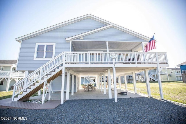 130 Crab St, Holden Beach, NC 28462 - rear view of property with a carport, stairs, a wooden deck, and a patio area