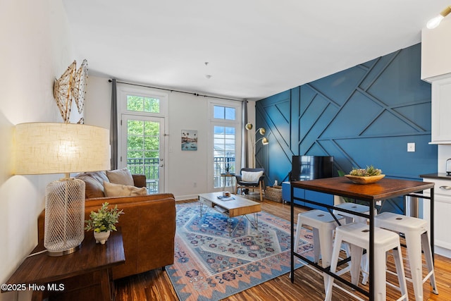 215 S Water St Apt 206, Wilmington, NC 28401 - living area featuring a decorative wall and wood finished floors