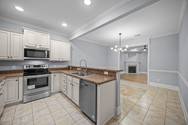 2324 Dovedale Dr Unit B, Greenville, NC 27834 - kitchen with appliances with stainless steel finishes, a peninsula, open floor plan, a fireplace, and light tile patterned floors
