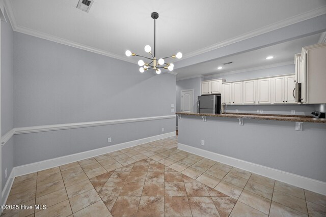 2324 Dovedale Dr Unit B, Greenville, NC 27834 - kitchen with appliances with stainless steel finishes, crown molding, a breakfast bar, dark stone countertops, and a peninsula