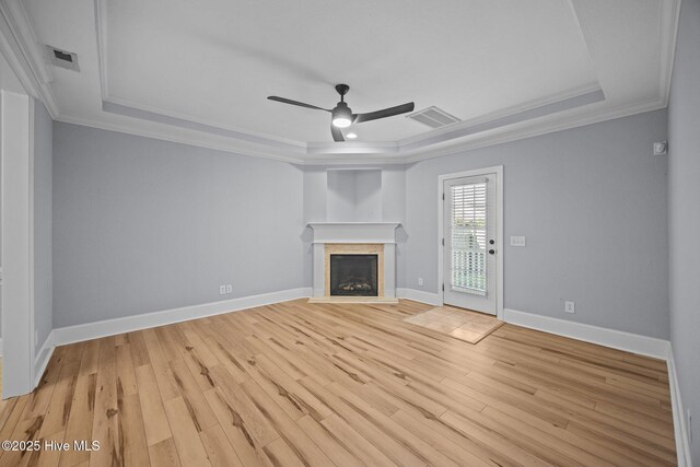 2324 Dovedale Dr Unit B, Greenville, NC 27834 - unfurnished living room featuring a raised ceiling, a ceiling fan, light wood-type flooring, a fireplace, and ornamental molding