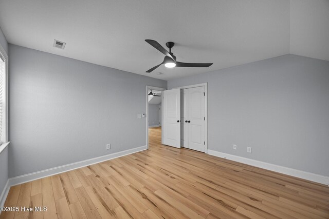 2324 Dovedale Dr Unit B, Greenville, NC 27834 - unfurnished bedroom featuring light wood finished floors, ceiling fan, and a closet