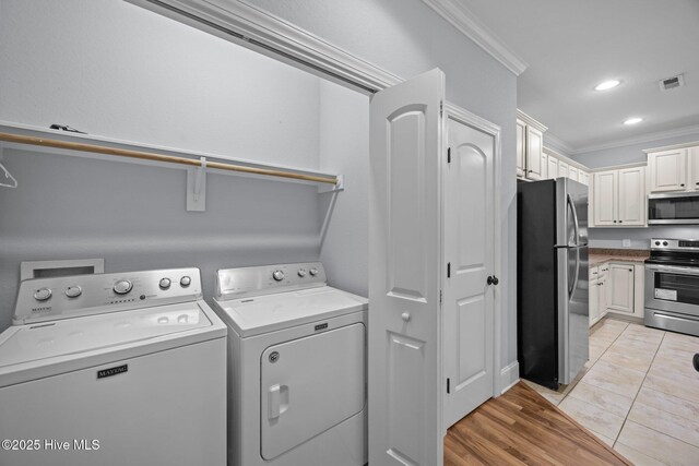 2324 Dovedale Dr Unit B, Greenville, NC 27834 - laundry room with ornamental molding, washing machine and clothes dryer, recessed lighting, and light tile patterned floors