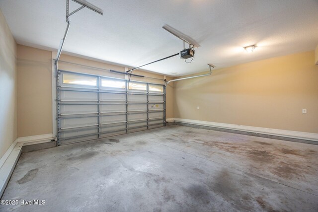 2324 Dovedale Dr Unit B, Greenville, NC 27834 - garage featuring a garage door opener and baseboards