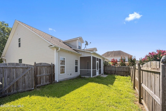2324 Dovedale Dr Unit B, Greenville, NC 27834 - back of property with a sunroom, a fenced backyard, a gate, and a shingled roof