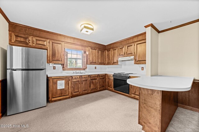 6715 Clarks Neck Rd, Washington, NC 27889 - kitchen featuring freestanding refrigerator, black electric range oven, a peninsula, brown cabinetry, and under cabinet range hood