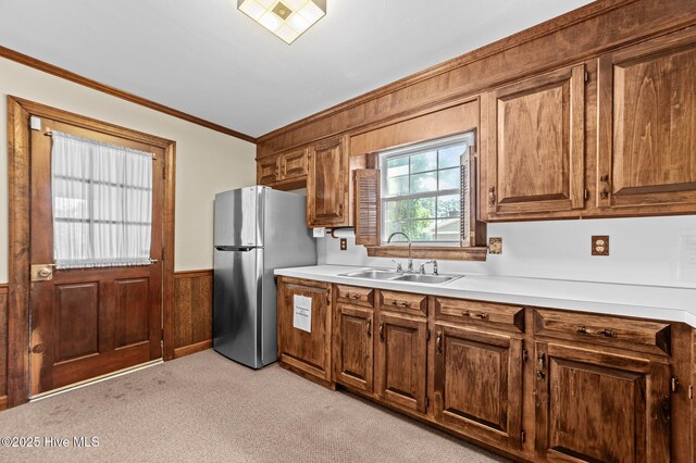6715 Clarks Neck Rd, Washington, NC 27889 - kitchen featuring freestanding refrigerator, ornamental molding, light countertops, light colored carpet, and wainscoting