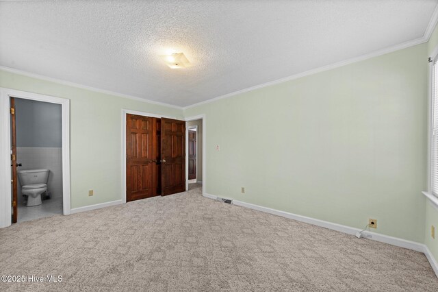 6715 Clarks Neck Rd, Washington, NC 27889 - unfurnished bedroom featuring crown molding, carpet, a textured ceiling, ensuite bathroom, and a closet