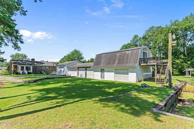 6715 Clarks Neck Rd, Washington, NC 27889 - rear view of house with a gambrel roof, a garage, stairs, a deck, and roof with shingles