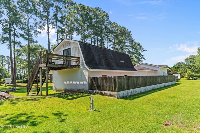 6715 Clarks Neck Rd, Washington, NC 27889 - back of property with stairway, a deck, a gambrel roof, and roof with shingles