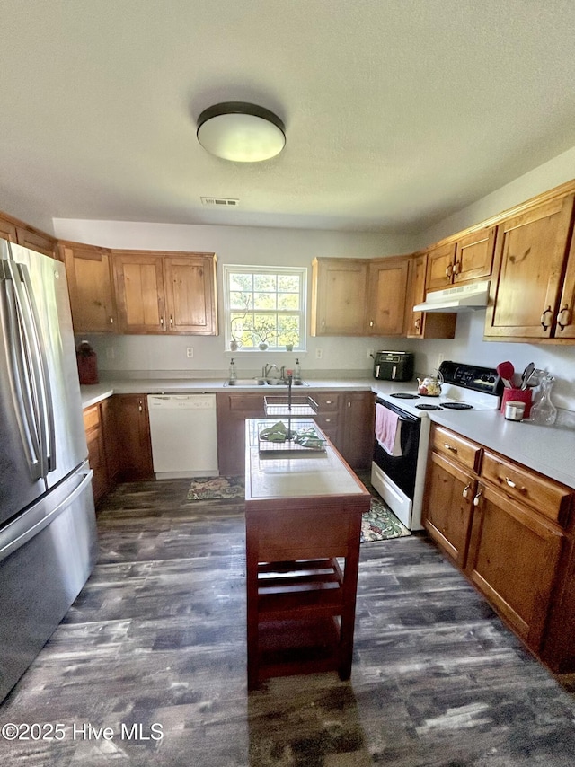 106 Cotton Ct, Camden, NC 27921 - kitchen featuring white appliances, under cabinet range hood, light countertops, and dark wood-type flooring