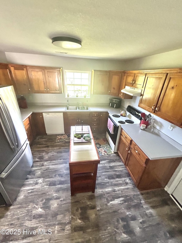 106 Cotton Ct, Camden, NC 27921 - kitchen with white appliances, under cabinet range hood, light countertops, and a center island
