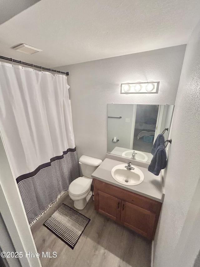 106 Cotton Ct, Camden, NC 27921 - full bath with wood finished floors, a textured wall, vanity, and a shower with curtain
