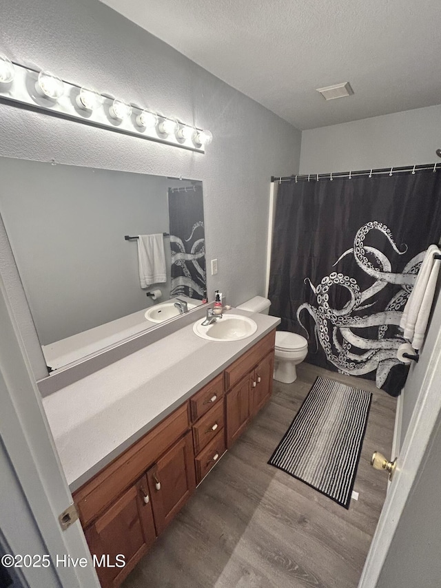 106 Cotton Ct, Camden, NC 27921 - full bathroom with vanity, wood finished floors, a textured ceiling, and a shower with curtain
