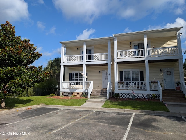 3 Sloop St, Swansboro, NC 28584 - view of front facade with a balcony, covered porch, and uncovered parking