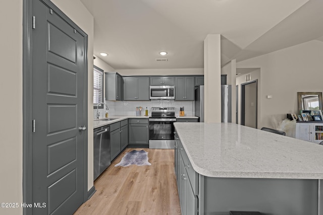 125 Trellis Ln, Vanceboro, NC 28586 - kitchen with appliances with stainless steel finishes, gray cabinets, a kitchen island, healthy amount of natural light, and recessed lighting