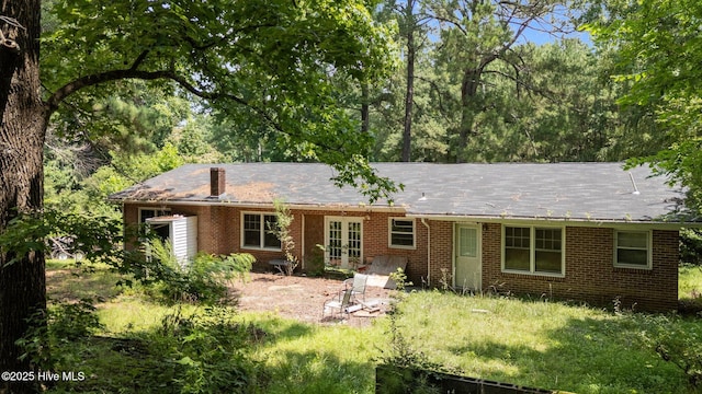 916 Corbitt Dr, Weldon, NC 27890 - back of property with french doors, brick siding, and a chimney