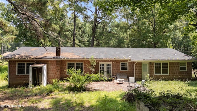 916 Corbitt Dr, Weldon, NC 27890 - rear view of house featuring brick siding, french doors, and a chimney