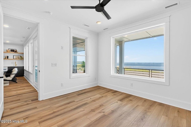47 Grande View Dr, Ocean Isle Beach, NC 28469 - empty room featuring ornamental molding, light wood-style flooring, ceiling fan, a water view, and recessed lighting