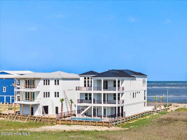 47 Grande View Dr, Ocean Isle Beach, NC 28469 - back of property with a water view, a balcony, and an outdoor pool