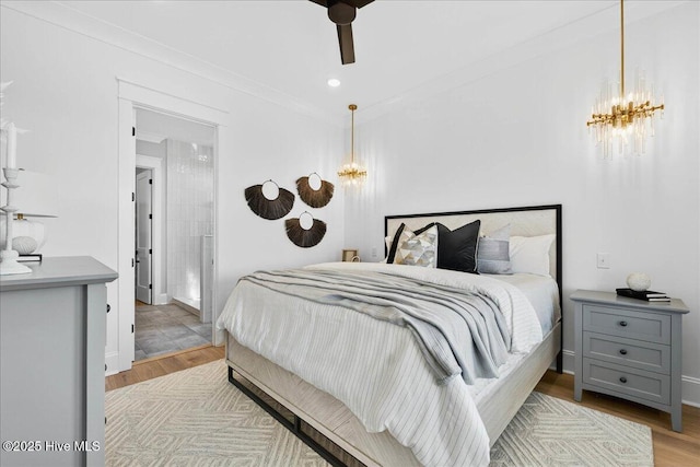47 Grande View Dr, Ocean Isle Beach, NC 28469 - bedroom with a chandelier, light wood-type flooring, and ceiling fan