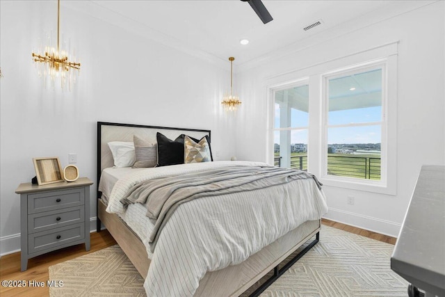 47 Grande View Dr, Ocean Isle Beach, NC 28469 - bedroom featuring a chandelier, wood finished floors, a ceiling fan, and recessed lighting