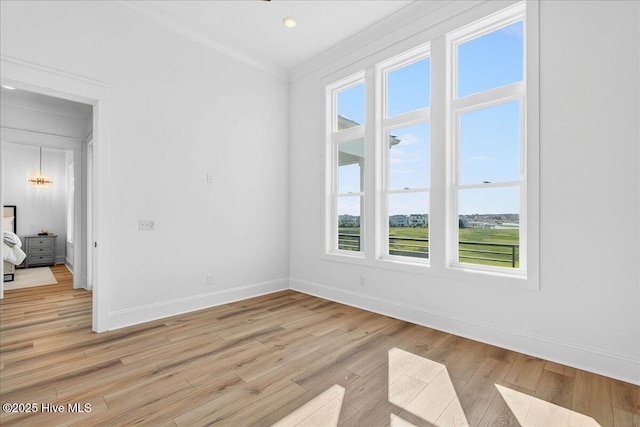 47 Grande View Dr, Ocean Isle Beach, NC 28469 - unfurnished room featuring plenty of natural light, light wood-type flooring, and crown molding