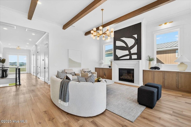 47 Grande View Dr, Ocean Isle Beach, NC 28469 - living area featuring beamed ceiling, light wood-style floors, a glass covered fireplace, recessed lighting, and a chandelier