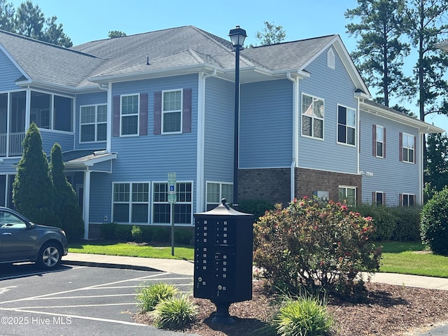 1908 Covengton Way Unit 102, Greenville, NC 27858 - view of home's exterior with mail area, uncovered parking, and brick siding