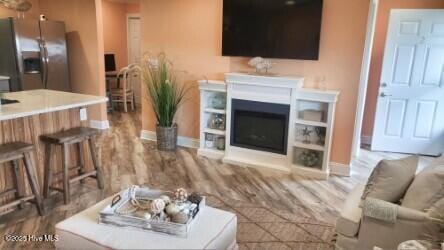 109 Cedar Ln Unit 2, Cedar Point, NC 28584 - living area with baseboards and a fireplace