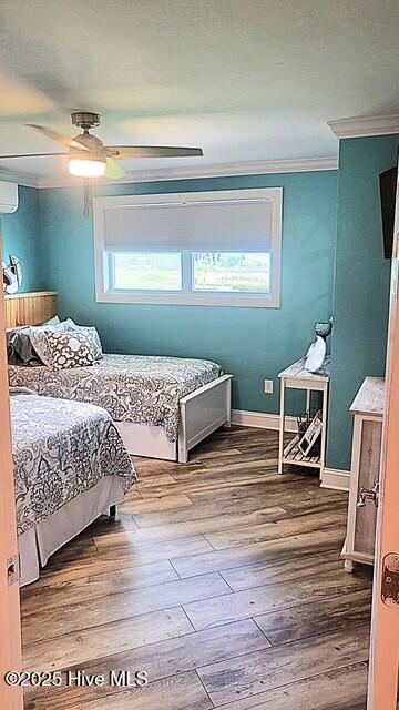 109 Cedar Ln Unit 2, Cedar Point, NC 28584 - bedroom with ornamental molding, wood finished floors, and a ceiling fan