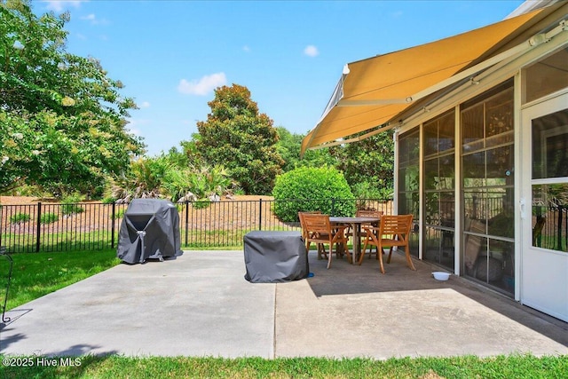5198 Windlass Rd, Southport, NC 28461 - fenced backyard with a patio, outdoor dining area, and area for grilling
