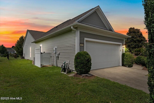 5198 Windlass Rd, Southport, NC 28461 - property exterior at dusk with driveway, a garage, and roof with shingles