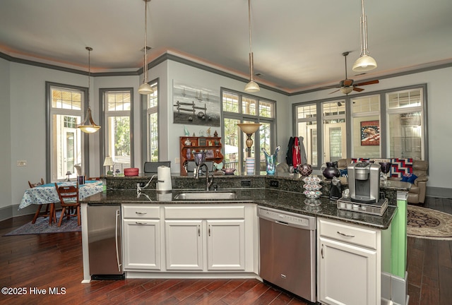 6601 Annesbrook Pl, Ocean Isle Beach, NC 28469 - kitchen with stainless steel dishwasher, open floor plan, a ceiling fan, dark stone counters, and dark wood finished floors