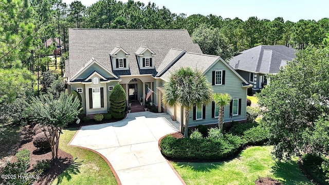 6601 Annesbrook Pl, Ocean Isle Beach, NC 28469 - view of front facade with concrete driveway, an attached garage, and a shingled roof